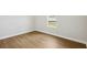 Cozy bedroom showcasing wood-look flooring and a bright window, creating a warm and inviting atmosphere at 15003 Rider Pass Dr, Lithia, FL 33547