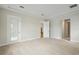 Large bedroom with neutral carpeting and doors leading to the outside and bathroom at 15003 Rider Pass Dr, Lithia, FL 33547