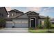 Lovely home with a two-car garage, beautiful landscaping, and warm lighting at 15003 Rider Pass Dr, Lithia, FL 33547
