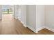 Light-filled hallway showcasing beautiful wood flooring and clean, neutral walls and trim at 15003 Rider Pass Dr, Lithia, FL 33547