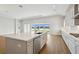 Gourmet kitchen island features stainless steel appliances and access to sliding doors with water views at 15003 Rider Pass Dr, Lithia, FL 33547