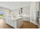 Bright kitchen featuring white cabinets, stainless steel appliances, and a large island at 15003 Rider Pass Dr, Lithia, FL 33547