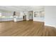 Expansive living area showcasing wood floors and connecting seamlessly to an open kitchen at 15003 Rider Pass Dr, Lithia, FL 33547