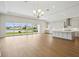 Spacious living room adjoins kitchen and features scenic backyard water views from sliding glass doors at 15003 Rider Pass Dr, Lithia, FL 33547