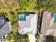 Aerial view showcasing a private backyard pool and spa, enclosed within a screened lanai at 15209 Hammock Chase Ct, Odessa, FL 33556