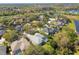 Expansive aerial view of a residential community with mature landscaping, screened-in pools, and serene lakes at 15209 Hammock Chase Ct, Odessa, FL 33556