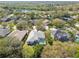 Expansive aerial view of a residential community with mature landscaping, screened-in pools, and serene lakes at 15209 Hammock Chase Ct, Odessa, FL 33556