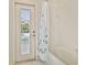 Bathroom with bathtub, shower, door, white tile and partial pool view at 15209 Hammock Chase Ct, Odessa, FL 33556