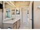 Bathroom with a vanity featuring a stone countertop and an adjacent bedroom entry at 15209 Hammock Chase Ct, Odessa, FL 33556