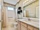 Bathroom featuring a vanity with a cultured marble countertop and a combined tub and shower at 15209 Hammock Chase Ct, Odessa, FL 33556