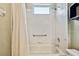 Bathroom featuring a tub/shower combination with white tile surround and safety grab bar at 15209 Hammock Chase Ct, Odessa, FL 33556