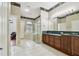 Spacious bathroom with double vanity, glass shower, soaking tub, and decorative wallpaper border at 15209 Hammock Chase Ct, Odessa, FL 33556