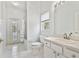 Bright bathroom with a white vanity, toilet, and shower/tub combo with access to the pool area at 15209 Hammock Chase Ct, Odessa, FL 33556