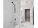 White tiled bathroom with a shower, bathtub, and view to a bedroom at 15209 Hammock Chase Ct, Odessa, FL 33556