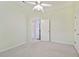 Spacious bedroom with neutral walls, a ceiling fan and access to hallway and adjacent room at 15209 Hammock Chase Ct, Odessa, FL 33556