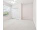 Neutral bedroom featuring a double closet with a window providing natural light at 15209 Hammock Chase Ct, Odessa, FL 33556