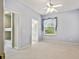 Serene bedroom featuring neutral carpet, a large window, and ensuite bathroom at 15209 Hammock Chase Ct, Odessa, FL 33556