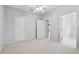 Neutral carpeted bedroom with an open door and a view to a bathroom at 15209 Hammock Chase Ct, Odessa, FL 33556