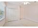Bright bedroom with neutral carpet, a window with blinds, and a double door closet at 15209 Hammock Chase Ct, Odessa, FL 33556