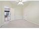 Light green bedroom with ceiling fan and entry door visible to the dining area at 15209 Hammock Chase Ct, Odessa, FL 33556