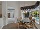 Cozy dining area with chandelier, glass table and wood flooring at 15209 Hammock Chase Ct, Odessa, FL 33556