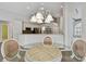 Dining area with chandelier next to open kitchen and great lighting at 15209 Hammock Chase Ct, Odessa, FL 33556