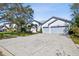 Beautiful home featuring a well-maintained lawn, mature trees, and a convenient two-car garage at 15209 Hammock Chase Ct, Odessa, FL 33556