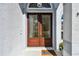Elegant entryway with double doors, complemented by a stylish hello mat and manicured greenery at 15209 Hammock Chase Ct, Odessa, FL 33556