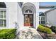 Elegant double front door with decorative glass panels, surrounded by lush landscaping and a charming fountain at 15209 Hammock Chase Ct, Odessa, FL 33556