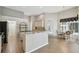 Kitchen featuring a breakfast bar, stainless steel appliances, and wood floors that flows to the dining area at 15209 Hammock Chase Ct, Odessa, FL 33556