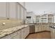 Bright kitchen with granite countertops, stainless steel appliances, and ample storage space at 15209 Hammock Chase Ct, Odessa, FL 33556