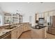 Well-equipped kitchen features granite countertops, stainless steel appliances, and stylish island for cooking at 15209 Hammock Chase Ct, Odessa, FL 33556