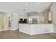 Kitchen featuring a breakfast bar, stainless steel appliances, and wood floors at 15209 Hammock Chase Ct, Odessa, FL 33556