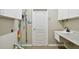 Functional laundry room with storage cabinets, utility sink, and convenient access to outdoor space at 15209 Hammock Chase Ct, Odessa, FL 33556