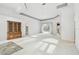 Spacious, bright living room with sliding doors to the pool, neutral walls, and a large decorative cabinet at 15209 Hammock Chase Ct, Odessa, FL 33556