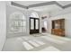 Spacious living area featuring large windows, neutral carpeting, and elegant furnishings for a comfortable setting at 15209 Hammock Chase Ct, Odessa, FL 33556