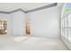 Bright living room with tray ceiling, white carpet, and shuttered windows for lots of natural light at 15209 Hammock Chase Ct, Odessa, FL 33556