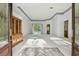 Bright, spacious living room with a view of the pool, featuring elegant tiled entryway and a built-in cabinet at 15209 Hammock Chase Ct, Odessa, FL 33556