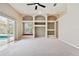 Sunlit living area featuring custom built-ins, plush carpeting, and seamless integration with outdoor pool area at 15209 Hammock Chase Ct, Odessa, FL 33556