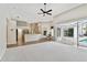 Bright living room featuring an open floor plan and sliding glass doors to the outdoor pool area at 15209 Hammock Chase Ct, Odessa, FL 33556