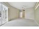 Spacious main bedroom with neutral walls, carpet, ceiling fan, and access to ensuite bathroom at 15209 Hammock Chase Ct, Odessa, FL 33556