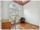 Bright office with hardwood floors, natural light from large window, desk, and a comfy leather chair at 15209 Hammock Chase Ct, Odessa, FL 33556
