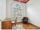 Office featuring hardwood floors, large window, desk, and a comfy leather chair at 15209 Hammock Chase Ct, Odessa, FL 33556