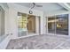 Covered patio with brick floor and access to the interior through glass sliding doors at 15209 Hammock Chase Ct, Odessa, FL 33556
