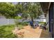 Backyard view of a new wooden deck, chairs, and landscaping at 2908 Longbrooke Way, Clearwater, FL 33760