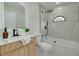Modern bathroom featuring a glass enclosed tub, wood vanity, and sleek fixtures at 2908 Longbrooke Way, Clearwater, FL 33760