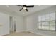 Spacious bedroom with wood floors, a ceiling fan, closet, and adjacent bathroom at 2908 Longbrooke Way, Clearwater, FL 33760