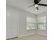 Light-filled bedroom with wood floors, a ceiling fan, and a closet at 2908 Longbrooke Way, Clearwater, FL 33760