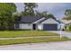 Single-story home featuring a well-maintained lawn, and a two-car garage, with brick and siding at 2908 Longbrooke Way, Clearwater, FL 33760