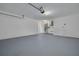 Clean, painted garage with epoxy floor and utility equipment at 2908 Longbrooke Way, Clearwater, FL 33760